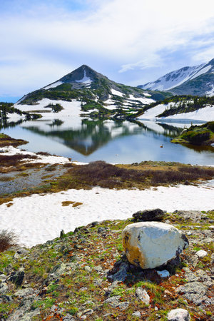 Snowy Range Mountains and lake with reflection in Medicine Bow, Wyoming in summerの写真素材