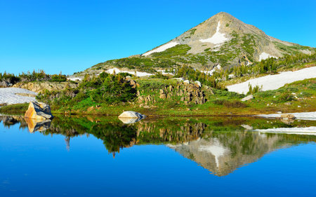 Snowy Range Mountains and alpine lake with reflection in Medicine Bow, Wyoming in summer