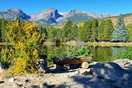 Mountains and alpine lake with reflection in daylight during the fall seasonの写真素材