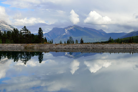 Beautiful high mountains of the Canadian Rockies reflecting in an alpine lake along the Icefields...