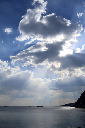 Seascape with Sun rays falling throw the clouds