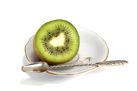 Half a kiwi on dishの写真素材