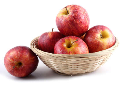 Gala apples on wicked plateの写真素材