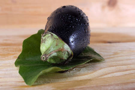 Aubergine and leaf on tableの写真素材