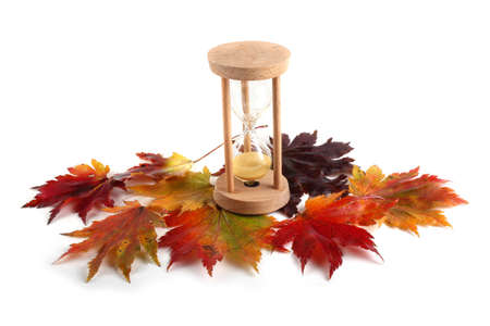 Sandglass and fallen leavesの写真素材