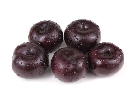 Black plums isolated on whiteの写真素材