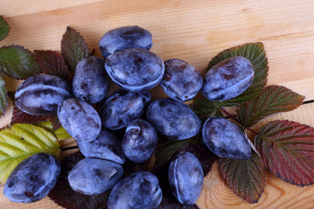 Black plums on table