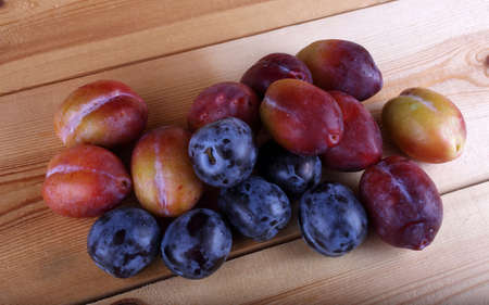 Plums on table. Fresh fruitsの写真素材