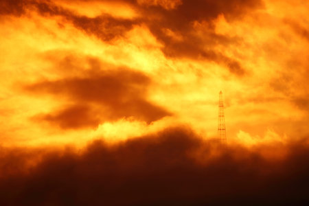 TV tower in fire clouds. Apocalyptic cloudscape