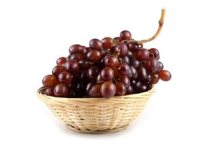 Brown grape on wicker plateの写真素材