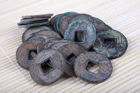 Ancient Chinese coins on bamboo background. Symbol of luckの写真素材
