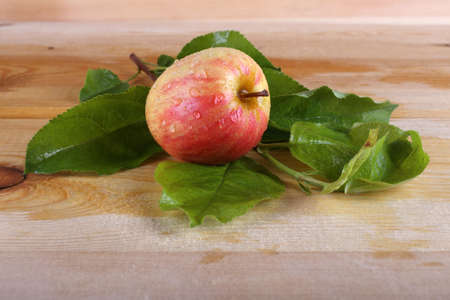 Apple and leaves on tableの写真素材