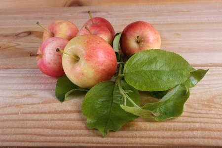 Apples and leaves on tableの写真素材