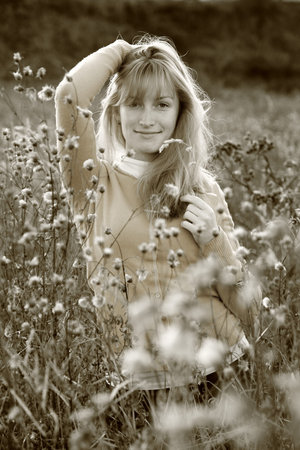 October 13, 2014 - A girl among fluffy flowers in the field.のeditorial素材