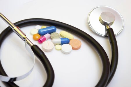 Background medicine stethoscope with pills - protection against flu during quarantine, coronavirus, covid19の写真素材