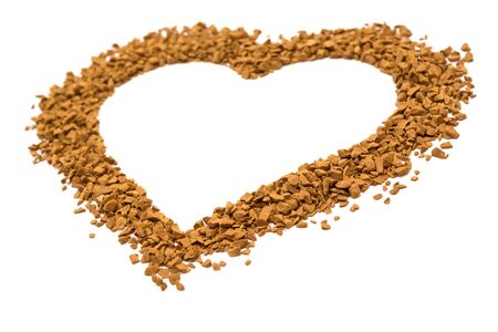 Dry instant coffee granules in the shape of a heart - brown texture, on a white backgroundの写真素材