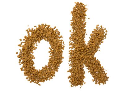 Dry instant coffee granules in the shape of a ok sign - brown texture, on a white backgroundの写真素材