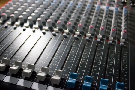 Console of a professional mixer with a lot of controls - music, concert
