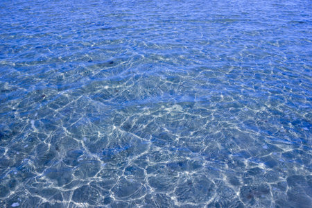 Texture of transparent sea waves in sunlight - top view