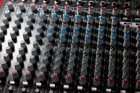 Console of a professional mixer with a lot of controls - music, concert