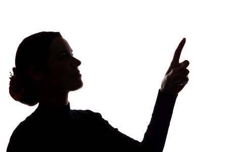 Young woman in suit shows his index finger, hand forward - silhouetteの写真素材