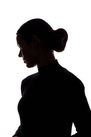 Silhouette of a young woman in sorrow - vertical silhouettesの写真素材