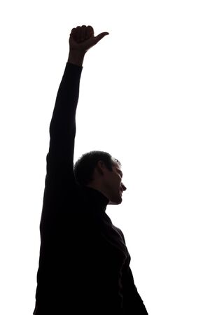 Man's hand shows a symbol of a ok over his head - silhouetteの写真素材