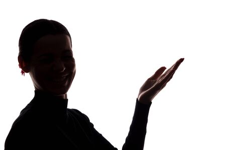 Young woman in suit shows his index finger, hand forward - silhouetteの写真素材