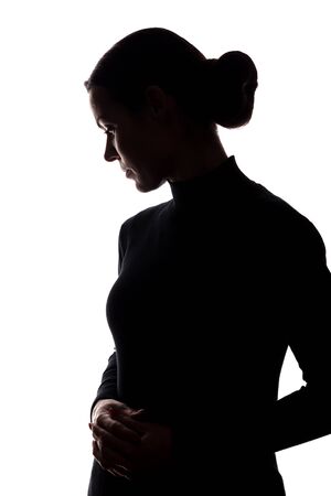 Silhouette of a young woman in sorrow - vertical silhouettesの写真素材