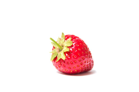 Red and ripe strawberry lies on its side on a white background - Isolate