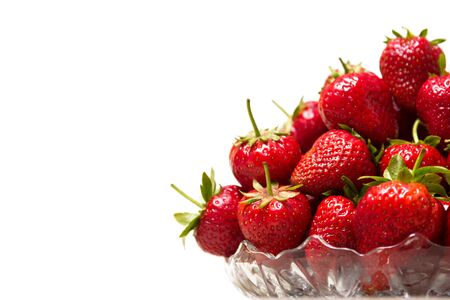 Ripe tasty strawberries in a glass vase on a white backgroundの写真素材