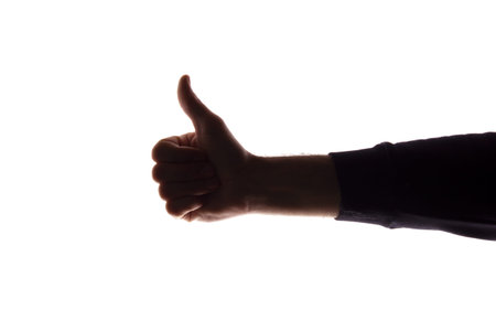 Hand of a young man with a raised finger, like and approval - silhouette concept abstraction