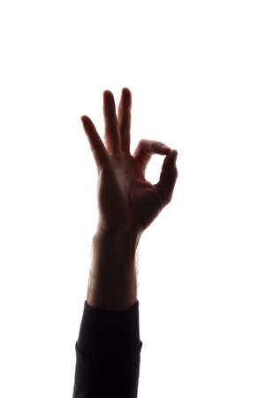 Hand of a young man shows symbol ok, like and approval - silhouette concept abstractionの写真素材