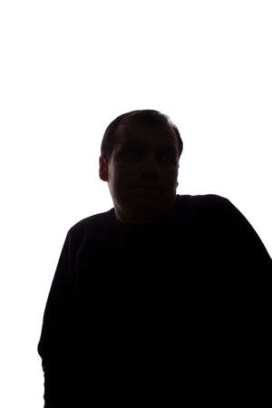 Portrait of a young man, unshaven, front view raised his index finger up idea - dark isolated silhouetteの写真素材