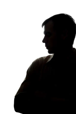 Portrait of a young man looking down, think, side view - silhouetteの写真素材
