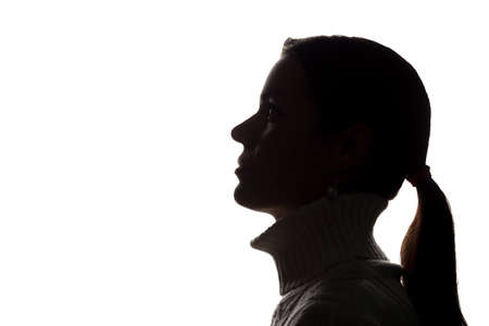Young woman looking up - horizontal silhouette of a side viewの写真素材