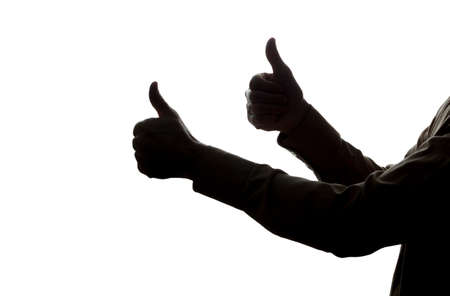 Man's hands shows a symbol of a ok - silhouetteの写真素材