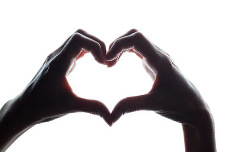 Female hands as a symbol of the heart - horizontal silhouetteの写真素材