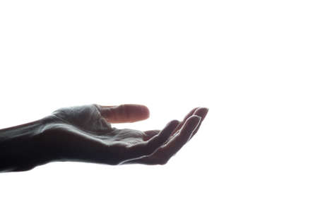 Women hand stretched forward with a request for assistance, alms, keeps the product - silhouetteの写真素材