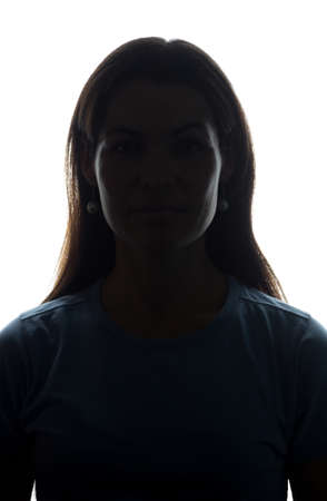 Young woman look ahead with flowing hair - vertical, isolated silhouette of a front viewの写真素材