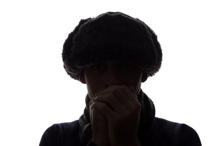 Young man in hat and gloves look ahead - horizontal silhouette of a front view