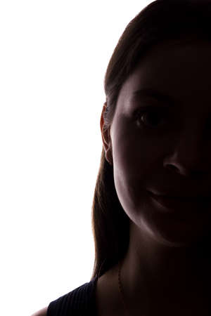 Young woman look ahead with flowing hair - vertical, isolated silhouette of a front viewの写真素材