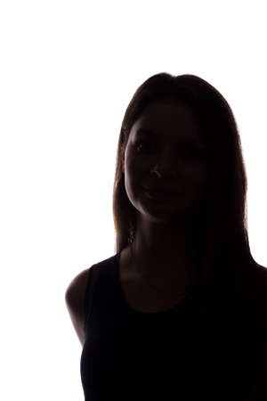 Young woman look ahead with flowing hair - vertical, isolated silhouette of a front viewの写真素材