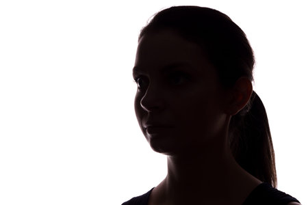 Young woman look ahead with flowing hair - horizontal silhouette of a front viewの写真素材