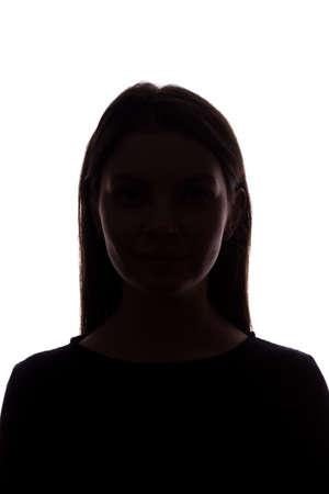 Young woman look ahead with flowing hair - silhouette of a front viewの写真素材