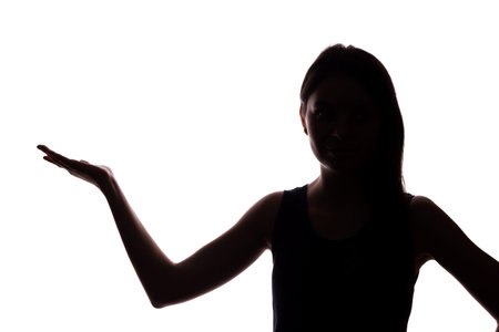 Young woman in suit shows his index finger, hand forward - silhouette