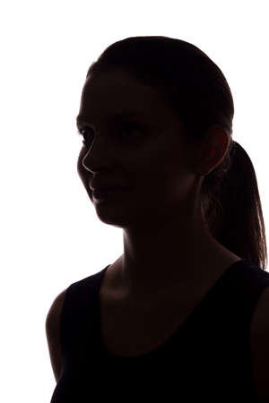 Young woman look ahead with flowing hair - vertical, isolated silhouette of a front viewの写真素材
