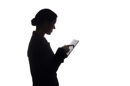 Young woman in suit look ahead and shows pointer forward - silhouetteの写真素材