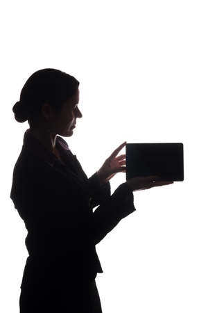 Young woman in suit look ahead and shows pointer forward - silhouetteの写真素材