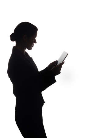 Young woman in suit look ahead and shows pointer forward - silhouetteの写真素材
